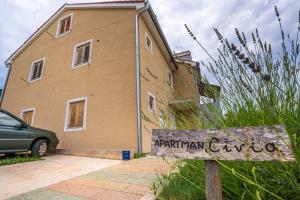 a sign in front of a building at Apartment Livia in Cres
