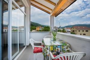 einen Tisch und Stühle auf einem Balkon mit Aussicht in der Unterkunft Apartment Livia in Cres