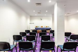 a room with chairs and a table in the background at Hotel Residencial Colibri in Costa da Caparica