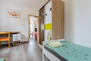 a small bedroom with a bed and a desk at Apartment Livia in Cres
