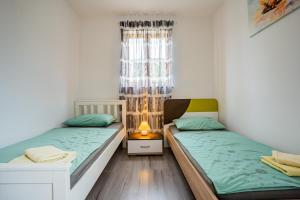 a bedroom with two beds and a window at Apartment Livia in Cres