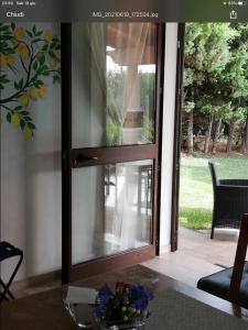 a sliding glass door with a view of a yard at La casa del melograno in Marsala
