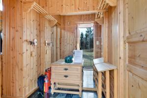 a wooden cabin with a desk and a chair at Bestefarhaugen - The cozy house on the hill - with a dome in Bø