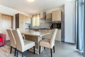 a kitchen with a table and chairs in a room at Apartment Livia in Cres