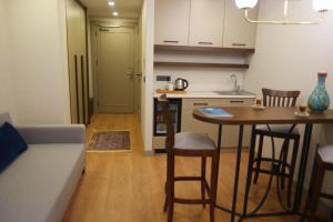 una cucina e un soggiorno con tavolo e sedie di Nevi Hotel & Suites Istanbul Taksim a Istanbul Altre 34 foto