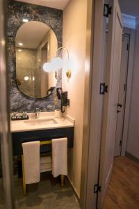 a bathroom with a sink and a mirror at Nevi Hotel & Suites Istanbul Taksim in Istanbul