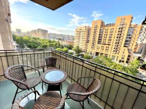 a balcony with four chairs and a table on a balcony at Apartments Emili in Yerevan