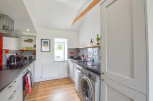 a kitchen with a washer and dryer at Easdale Cottage in Oban