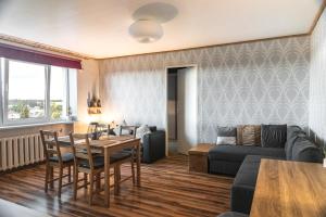 a living room with a couch and a table at Haapsalu Sky Seat in Haapsalu