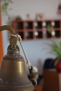 an old bell with a rope attached to it at Tranvía Beach House in Chipiona