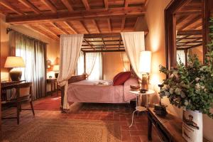 a bedroom with a bed and a large window at Casa Terzerie in Braccagni