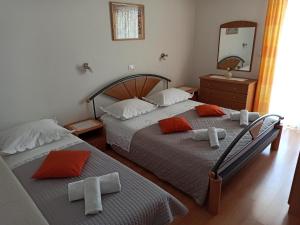 a bedroom with two beds and a mirror at Olivera in Promajna