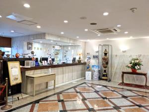 a restaurant with a counter and a counter sidx sidx sidx at Hotel New Century in Okinawa City