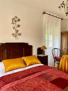 a bedroom with a large bed with yellow pillows at A Casa de Pia in Sober +72 photos