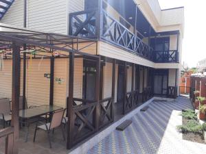 a patio with a table and chairs on a building at Caramel' in Chornomorsk