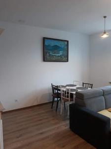 a living room with a table and a couch at Apartamenty pod Kicarzem in Piwniczna-Zdrój