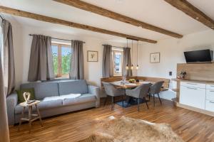 a living room with a couch and a table at Fewo beim Nik mit Wanderreitstation in Höslwang