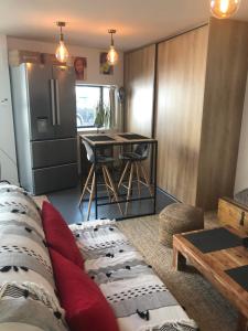 a living room with a couch and a table at Loft Mahanoa in Cabannes