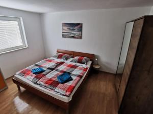 a bedroom with a bed with a quilt on it at Apartment Simona - Extra comfort with large terrace and jacuzzi in Barbariga