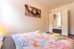 a bedroom with a large bed with two towels on it at Apartment Livia in Cres