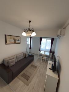 a living room with a couch and a table at Center Apartments in Iaşi