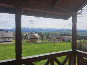 a view of the mountains from the porch of a house at Domek na Polnej in Czorsztyn
