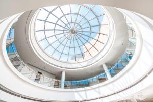 a dome of a building with a glass ceiling at Aram Hotel - AlMeshael Exit 18 in Riyadh