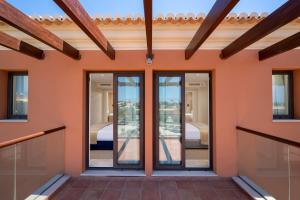 a pivot door in a house with glass doors and windows at Monte Santo Resort in Carvoeiro