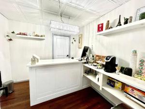 a white room with a counter and a window at Mount Coolidge Motel in Lincoln