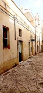 an empty street next to an old building at Otium Salento in Cutrofiano +8 photos