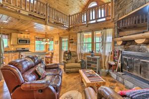 a living room with leather furniture and a fireplace at Charming Blakely Cabin with Porch and Valley Views! in Blakely