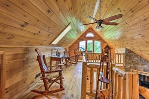 a dining room in a log cabin with a ceiling fan at Charming Blakely Cabin with Porch and Valley Views! in Blakely