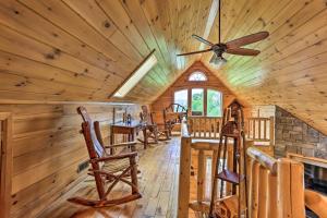 a dining room in a log cabin with a ceiling fan at Porch, Fire Pit and Valley Views Blakely Cabin! in Blakely