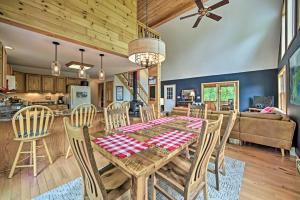 a dining room and living room with a table and chairs at Rustic North Creek Getaway about 4 Mi to Gore Mtn! in North Creek