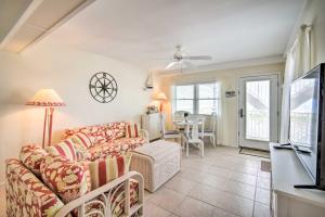 a living room with a couch and a tv and a table at Walk to Wildwood Beach Oceanfront Condo with View in Wildwood Crest
