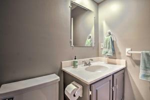 a bathroom with a sink and a toilet and a mirror at Modern Townhome with Fireplace Near Stoll Park in Overland Park