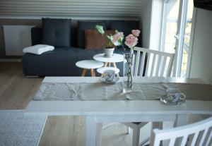 a living room with a white table with flowers on it at Kabelvåg Panorama in Kabelvåg