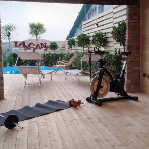 a exercise bike on the ground next to a pool at Agricola Lanciani in Montefiore dellʼAso