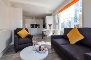 a living room with two couches and a table at The Westwood Summer Accommodation in Galway