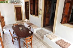 a room with a table and chairs and a door at Traditional Villa Efterpi in Halki