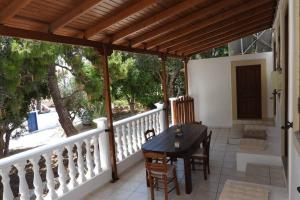 a patio with a table and chairs on a porch at Traditional Villa Efterpi in Halki