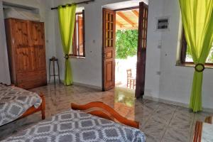 a bedroom with a bed and a door to a patio at Traditional Villa Efterpi in Halki