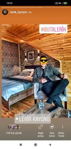 a picture of a man in a room with two beds at Buta Hotel Lerik in Lerik