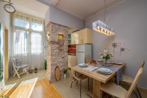 a kitchen and dining room with a table and chairs at Apartment Next To Amphitheatre in Pula