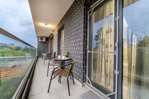 a balcony with chairs and a table on a building at URBAN LUXURY in Constanţa