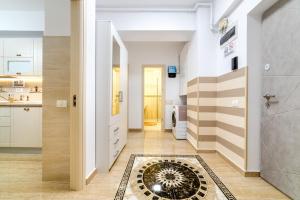 a hallway with a tile floor and a kitchen at URBAN LUXURY in Constanţa