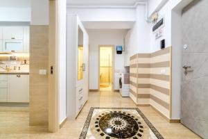 a hallway with a tile floor and a kitchen at URBAN LUXURY in Constanţa +55 photos