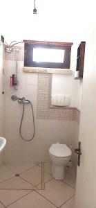 a bathroom with a shower and a toilet and a sink at Otium Salento in Cutrofiano