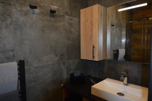 ein Bad mit einem Waschbecken und einem Spiegel in der Unterkunft Les villas du Golf Mougins in Mougins