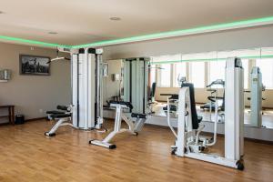 a gym with several exercise equipment in a room at Vila Gale Ericeira in Ericeira